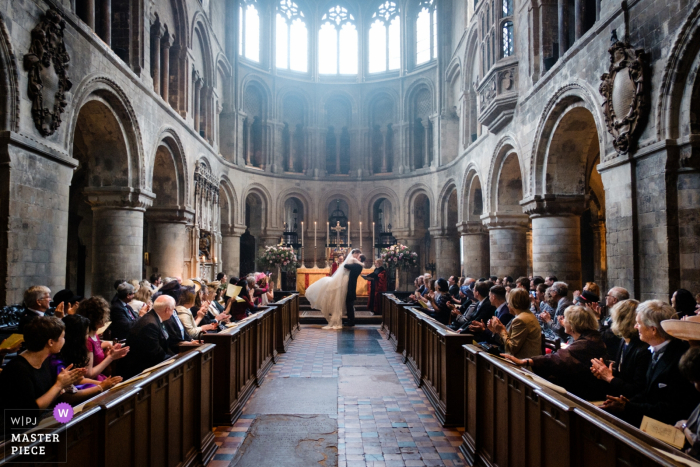 Ceremoniefotografie bij een bruiloft in St Bartholomew the Great, Londen | Eerste kus van bruid en bruidegom