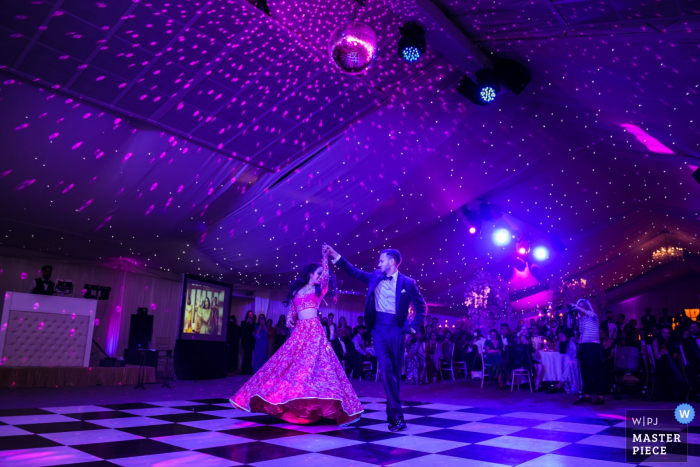 Photo by: <a href="https://www.wpja.com/contests/2019-v20/best-wedding-photographers/2577239">Jay Hoque - Uxbridge London</a> England wedding photography at Ditton Park Manor venue | First dance for the bride and groom under purple lights.