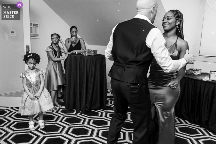 White House, Biloxi, MS Wedding image of the bride and groom dancing, with sad child off to the side