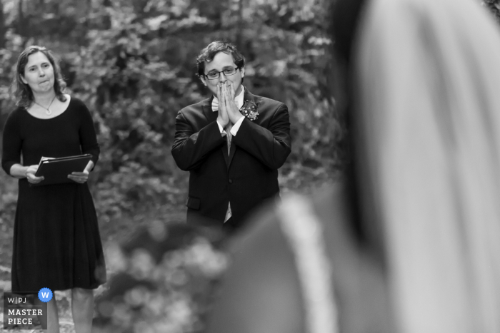 Tucker, GA Backyard Wedding | Groom reacts as he sees his bride coming down the aisle 