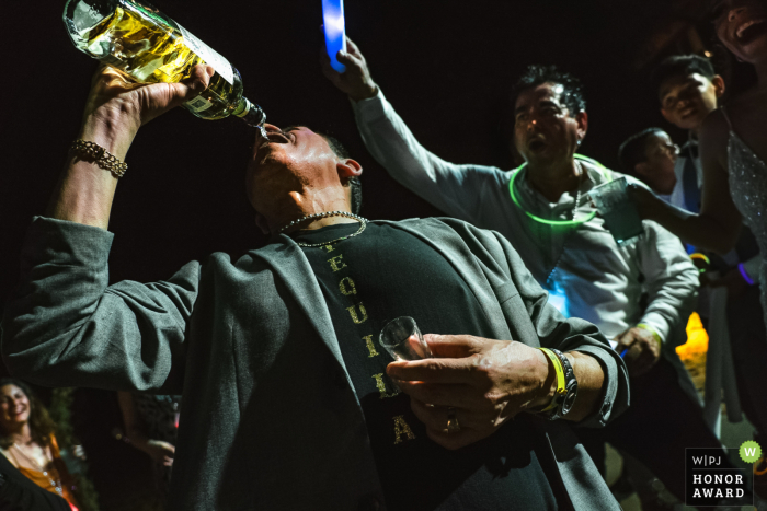 Mexico wedding photo from Las Caletas, Puerto Vallarta of The godfather of the bride drinking Mexican water