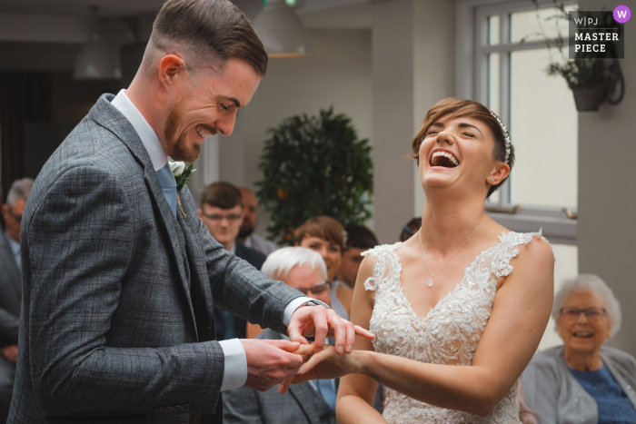 East Midlands Wedding Photographer | groom struggling to place ring on bride 