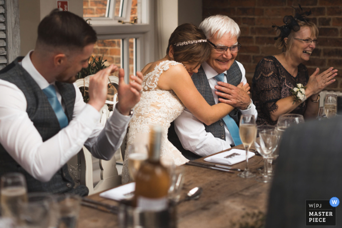 Kedleston Country House, reception image of the bride hugging father after his speech Kedleston Country House, reception image of the bride hugging father after his speech