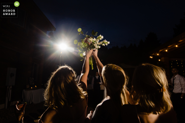 Philipsburg, Montana bouquet toss wedding photography shot at night