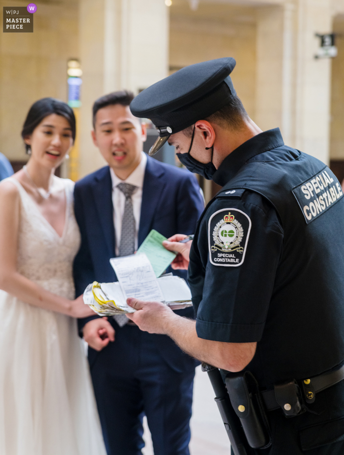 Union Station, Ontario Wedding Photo of a Cop issuing a ticket to bride and groom for not having a permit Union Station, Ontario Wedding Photo | Cop caught us without permit and issued a ticket to bride and groom - I thought to capture this moment