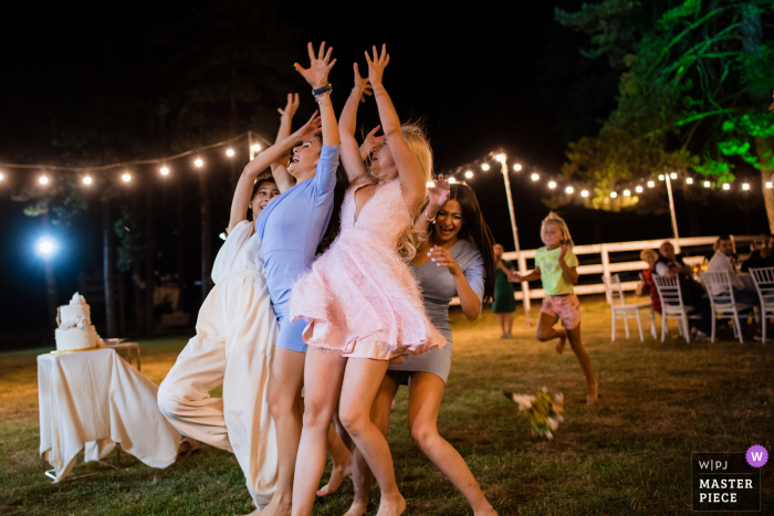 Guest House Ongal, Bulgaria Wedding Photographer | Bridesmaids fighting to catch the bridal bouquet. 