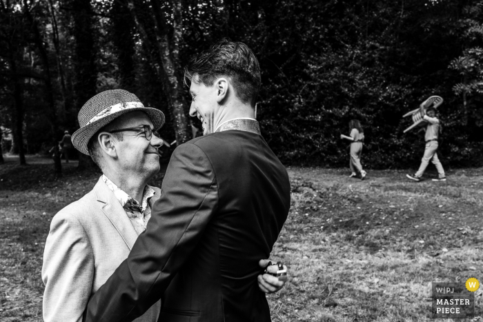 France wedding photography from outdoor venue in Carhaix of the Father in Law Hugging 