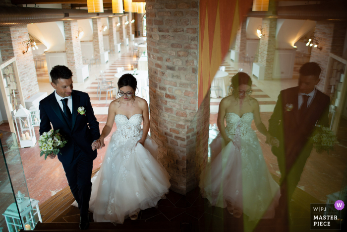 La Corte Berghemina, Pagazzano wedding photo of the bride and groom heading up the stairs for the start of the wedding party La Corte Berghemina, Pagazzano wedding photo of the bride and groom heading up the stairs for the start of the wedding party