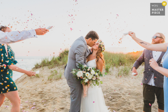 Outdoor, beach wedding photograph from Clark's Cove, Nantucket Island MA of Guests showering the newlyweds in dried flower confetti made by the bride from roses from their favorite beach Outdoor, beach wedding photograph from Clark's Cove, Nantucket Island MA of Guests showering the newlyweds in dried flower confetti made by the bride from roses from their favorite beach