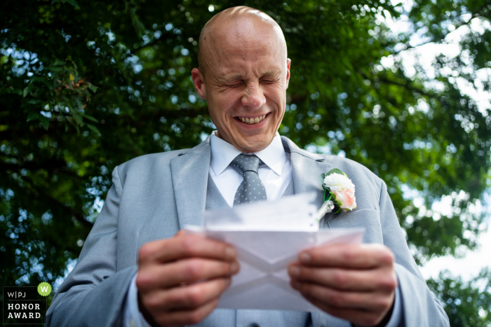 Atlanta Georgia outdoor wedding image of a groom reading a letter from the bride