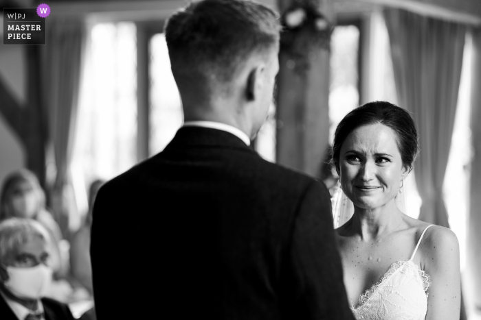 Bride tries not to cry during the wedding ceremony at Cain Manor, UK Bride tries not to cry during the wedding ceremony at Cain Manor, UK