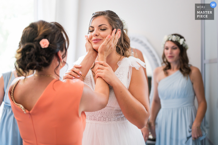 Domaine de Pécarrère, France bride has a tender moment with a close friend before her wedding ceremony