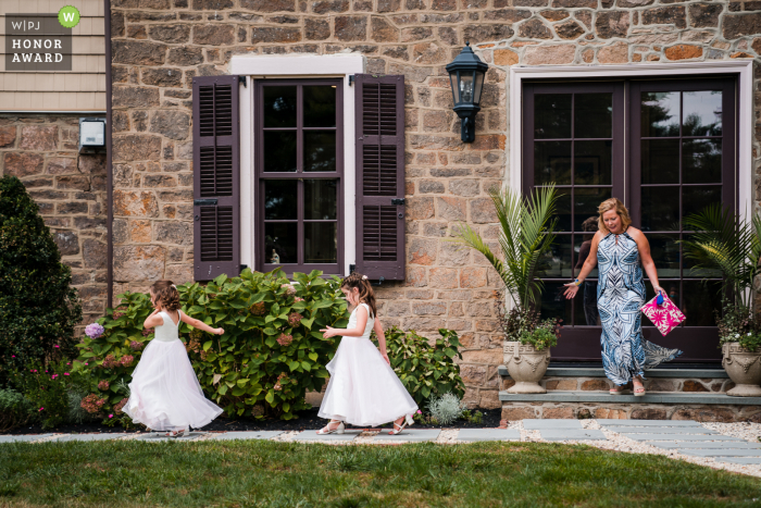 Pennsylvania outdoor wedding photo from the Backyard Wedding of Flower girls doing their thing as their Aunt continues to chase them around the house while waiting for the ceremony to start.