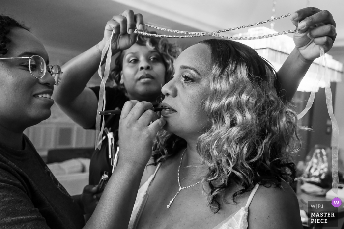 Bride gets help with makeup and jewelry at the Chateau Elan, Braselton, Georgia