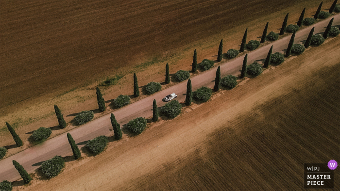 Puglia, Italy Bride and Groom in their car, aerial view from a drone camera Puglia, Italy Bride and Groom in their car, aerial view from a drone camera