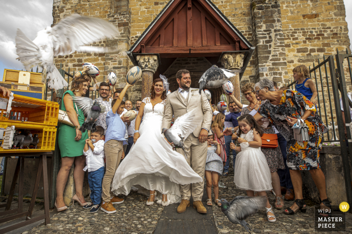 Occitanie wedding image from Behind church of the birds being released for the bride and groom Occitanie wedding image from Behind church of the birds being released for the bride and groom