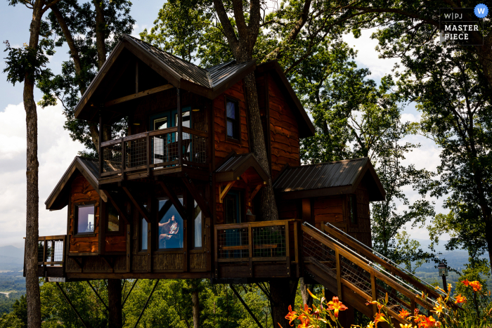 Colorado wedding Prep of ceremony in a treehouse with a clamped speed light and photographer waiting outside for makeup