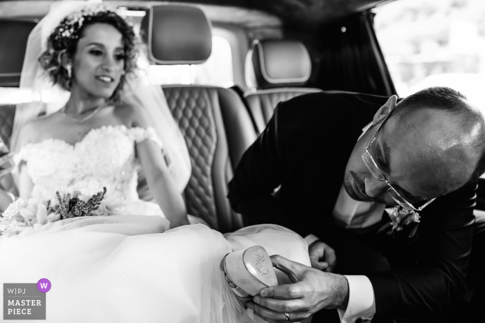 Istanbul wedding groom looks under the shoes to see whose name has been erased