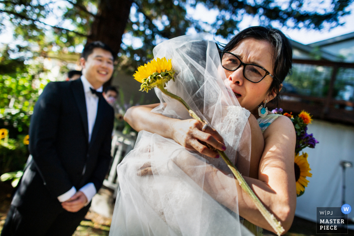 It's hard for the Mom to let go of her 'little' girl in this outdoor wedding image from San Francisco California at a Home backyard event