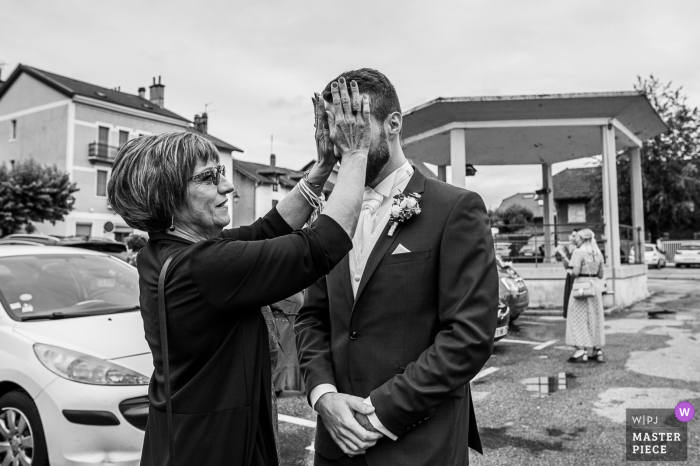 Groom's mom hides his eyes so he doesn't see the bride at the Chapareillan city hall, Savoie, France