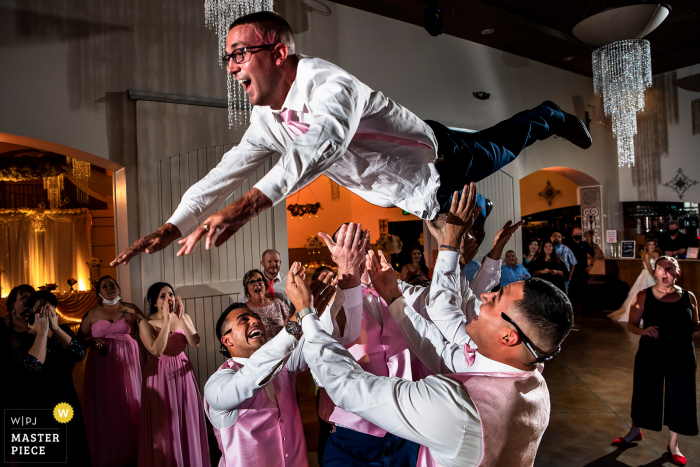 Wedding venue image of the Groom being thrown into the air by groomsmen at Bella Sera Event Center of Brighton, CO Wedding venue image of the Groom being thrown into the air by groomsmen at Bella Sera Event Center of Brighton, CO