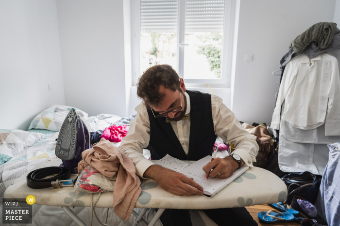 A Carhaix, France groom is copying his vows before his wedding ceremony