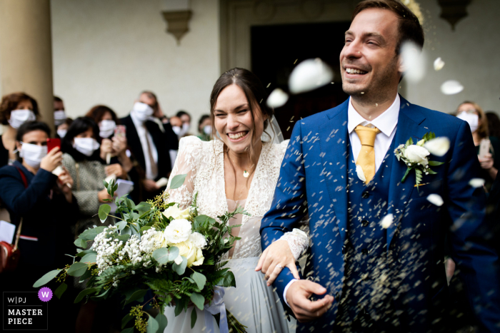 The throwing rice after the ceremony at San Martino a Mensola Church in Florence The throwing rice after the ceremony at San Martino a Mensola Church in Florence