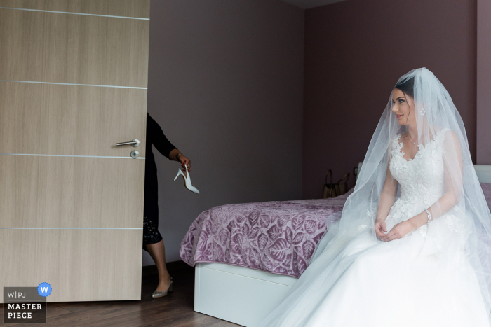 Bulgaria wedding photographer captures the bride expecting her groom to arrive at any moment 