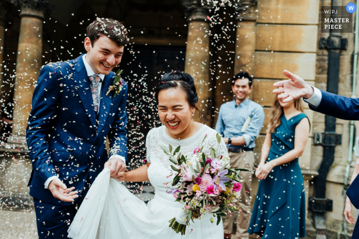 Hertford College Chapel, Oxford University wedding photographer, "Confetti outside the chapel. I got in really close with my 35mm for this shot to immerse myself in the moment"