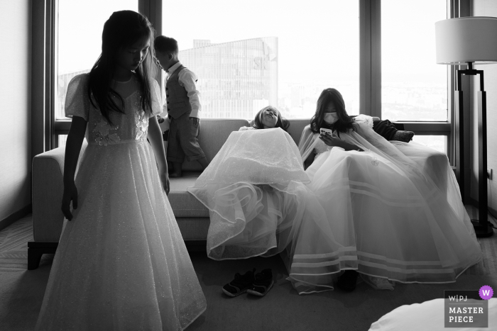 Beijing bridal party getting ready for the ceremony, as a flowergirl falls asleep Beijing bridal party getting ready for the ceremony, as a flowergirl falls asleep