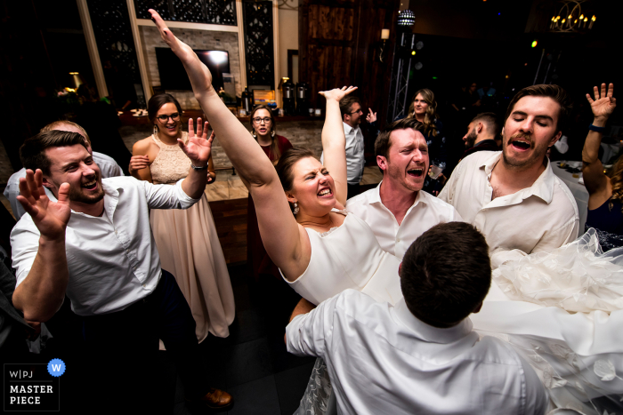 Bride being lifted into the air during dance party at the Pinery at the Hill (Colorado Springs, CO) 