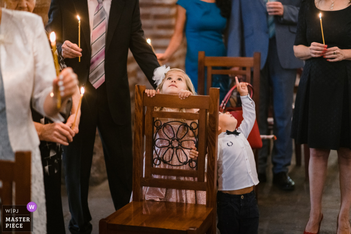 Huwelijksfotografie van St. Sofia Church / Sofia die de nieuwsgierigheid van Jonge geitjes toont tijdens de kerkceremonie