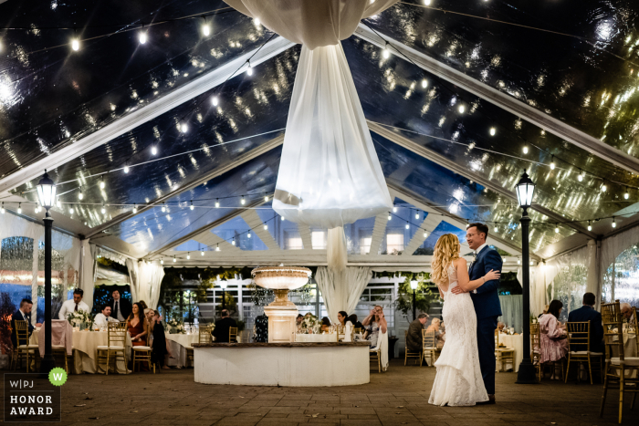 PA bride and groom enjoy the dance floor to themselves while their guests are being served salads