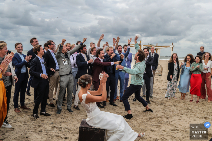 the bride's garter caught by the best friend of the groom on the Scheveningen Beach the bride's garter caught by the best friend of the groom on the Scheveningen Beach