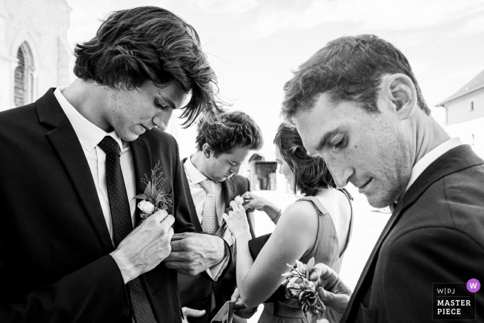 Friends of the bride and groom prepare before the religious ceremony in France