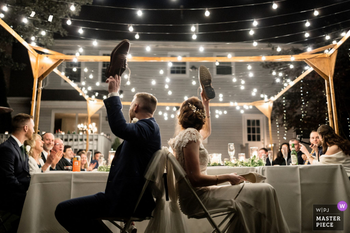 A bride and groom playing shoe game at their wedding reception in Boston, MA