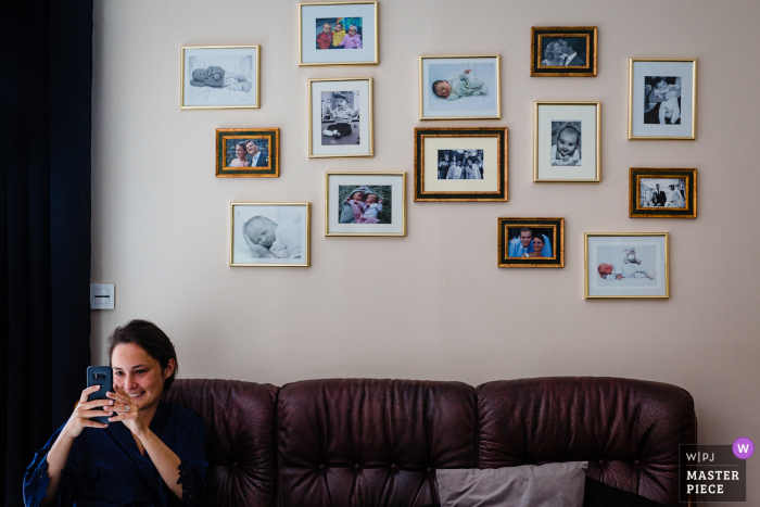 Frans bruidsmeisje maakt foto van de bruid tijdens de bruidsvoorbereidingen