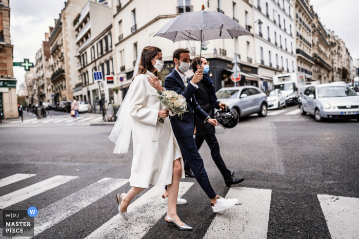 La novia y el novio están caminando hacia el Ayuntamiento de París, Francia