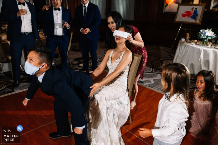 Ritz Carlton, Tyson's Corner in Virginia wedding image of the bride searching for the groom during the butt-touching game Ritz Carlton, Tyson's Corner in Virginia wedding image of the bride searching for the groom during the butt-touching game