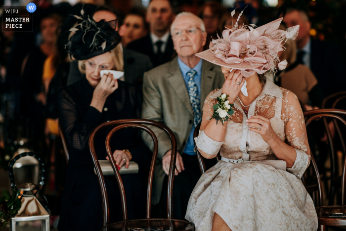 Mum and grandmother both cry together just before the bride enters the ceremony room at this UK wedding