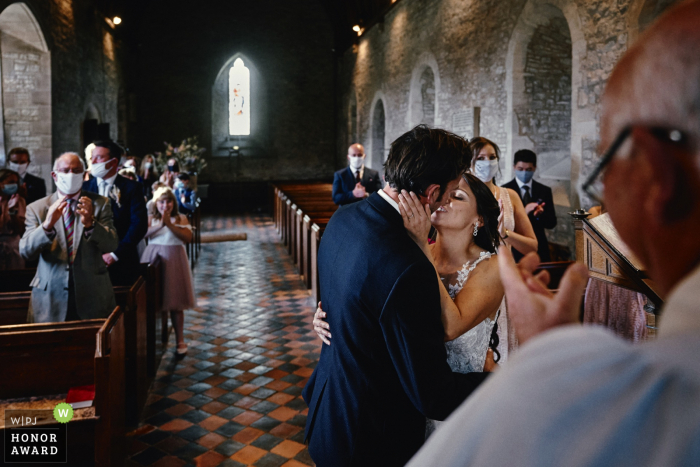 UK wedding photography from All Saints Church, Preston Bagot of the Bride and groom's first kiss during the ceremony UK wedding photography from All Saints Church, Preston Bagot of the Bride and groom's first kiss during the ceremony