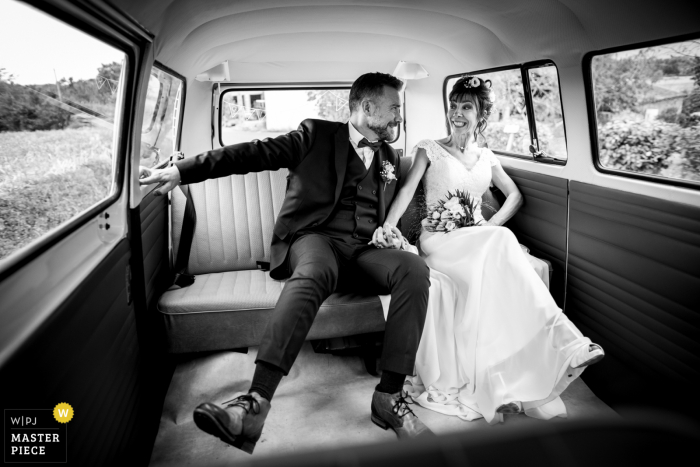 Occitanie wedding image of the bride and groom in a VW van as it was rolling on the turn road, hard to stay straight