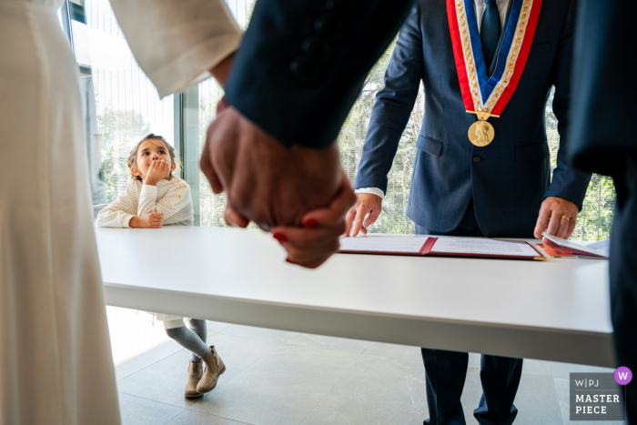 Imagen de la ceremonia de la boda de Montpellier de una joven esperando que los novios se besen