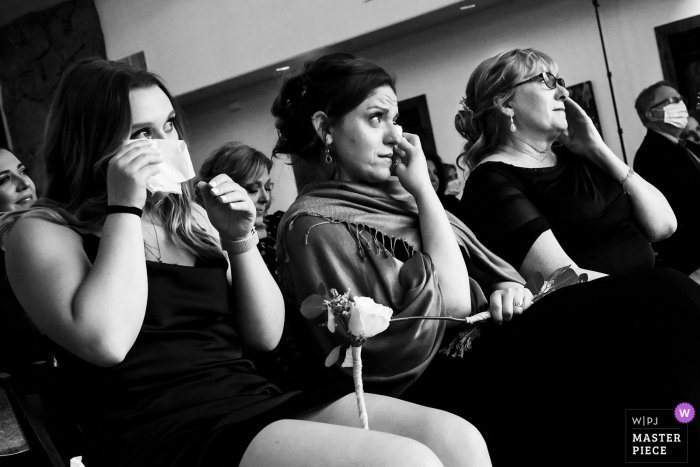 Photo by: <a href="https://www.wpja.com/contests/2020-v04/best-wedding-photographers/2603027">Jesse La Plante - Boulder Colorado</a> Black Canyon Inn Estes Park, CO wedding guests crying during ceremony in this candid photography