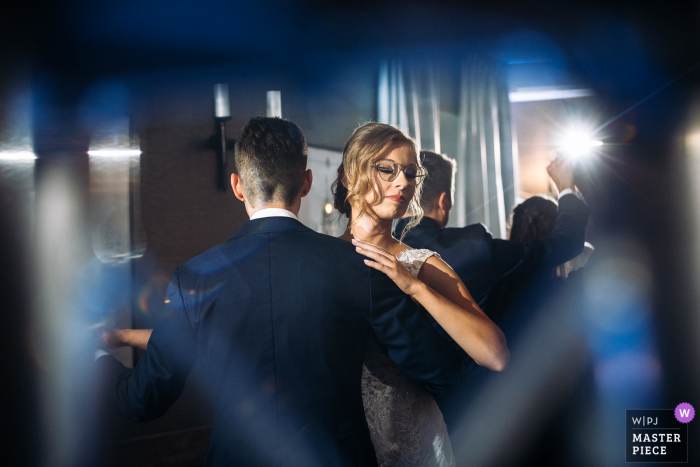 Lodzkie wedding photographer took this image at the Best Western Podklasztorze in Sulejow, Poland showing us the First dance of the bride and groom - A shot taken by through speaker stand