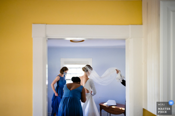 Fotografía de la boda de Vermont preparándose en Shelburne Farms, VT - La novia se prepara con la ayuda de sus damas de honor