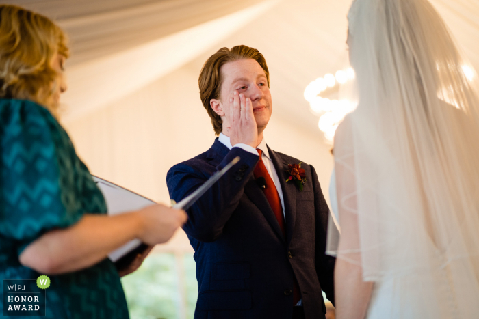 Georgia indoor wedding photography from the Atlanta ceremony as the groom is wiping away the tears