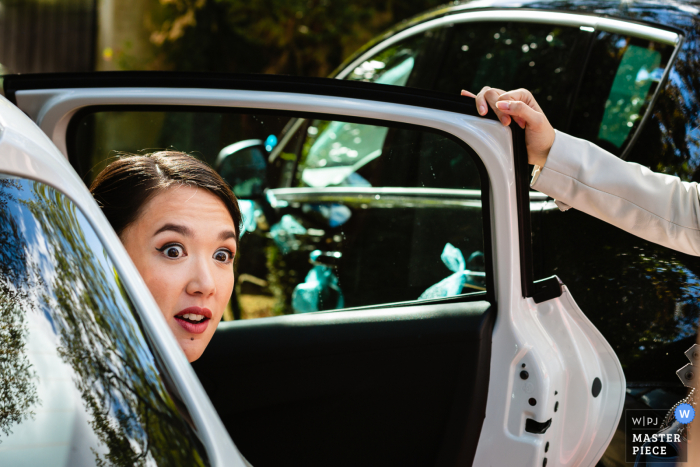 Huwelijksfotograaf in Frankrijk legde deze grappige blik vast in Île-de-France Voor de ceremonielocatie terwijl de bruid in haar auto arriveerde