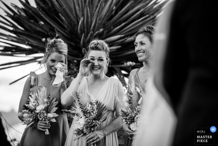 Texas wedding photo from Terlingua showing The wedding party reacting to the couples' vows.