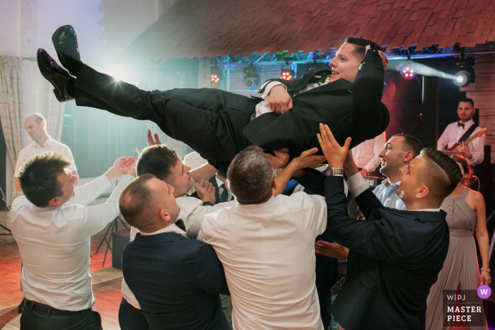 Photo by: <a href="https://www.wpja.com/contests/2020-v04/best-wedding-photographers/2605413">Wojciech Marzec - Krakow </a> Malopolskie wedding Reception Venue flying groom wedding image from Krakow